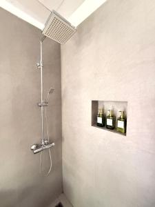 a bathroom with three soap bottles on a wall at Villa Kobeimalhena, Matara in Matara +56 photos