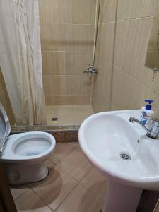 a bathroom with a toilet and a sink and a shower at Hostel Hostel in Batumi
