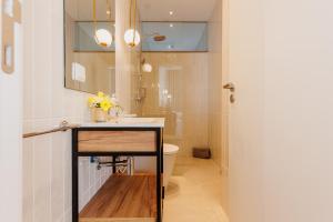 a bathroom with a sink and a toilet at Laranjal Rive Gauche in Tavira +70 photos