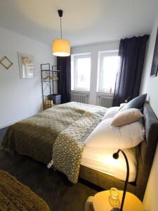 a bedroom with a bed and a window at Wohnen am Klinikum 2 in Oldenburg