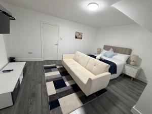 a living room with a bed and a couch at Bpsairbnbltd in London
