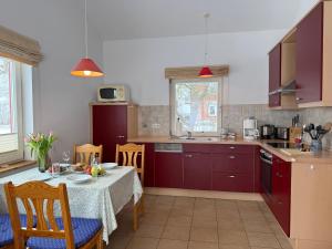 a kitchen with a table and a dining room at Seeschwalbe in Munkbrarup