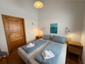 a bedroom with two beds with towels on them at Seeschwalbe in Munkbrarup