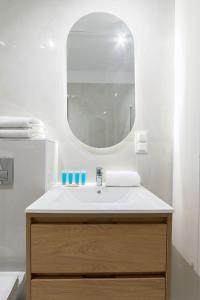 a bathroom with a sink and a mirror at Luboń Urban Nest Studio by BookingHost in Luboń +21 photos