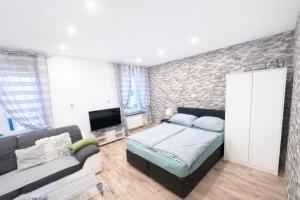 a living room with a bed and a couch at Ferienwohnung AyNa 2, direkt an der Schweizer Grenze in Bad Säckingen