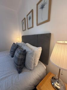 a bedroom with a bed with blue and white pillows at Misty Isles View in Portree +32 photos