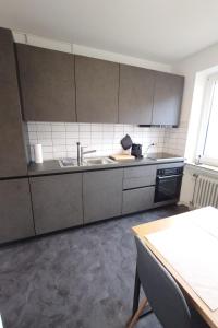a kitchen with a sink and a stove at Wohnen am Klinikum 2 in Oldenburg +15 photos