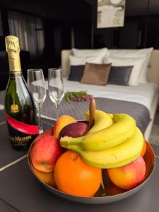 a bowl of fruit on a table with a bottle of wine at Hotel AP in Kalisz +41 photos