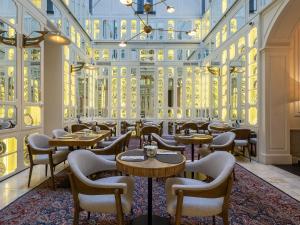 a restaurant with tables and chairs in a building at Only YOU Boutique Hotel Madrid in Madrid