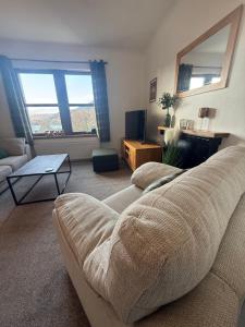 a living room with a couch and a table at Misty Isles View in Portree