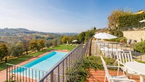 a villa with a swimming pool and a balcony at Relais Villa Olmo - Place of Charme in Impruneta