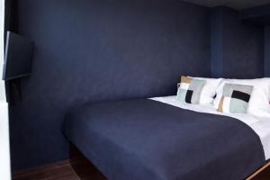 a bedroom with a bed with a blue wall at Base Apartments in Hamburg