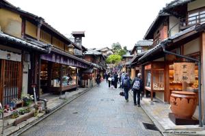 a group of people walking down a street with buildings at 媛楽園Himerakuen in Matsuyama