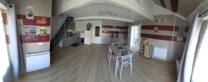 a room with a kitchen and a table and chairs at La maisonnette des Fontilles in Mauriac +11 photos