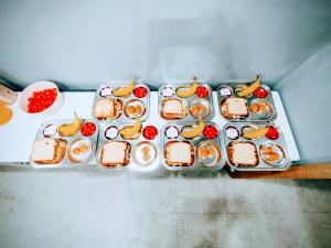 a tray of sandwiches and fruit on a table at 스테이 공담호텔 in Kyū-masan