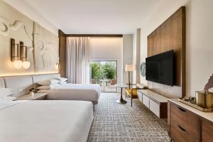 a hotel room with two beds and a flat screen tv at JW Marriott Tucson Starr Pass Resort in Tucson +70 photos