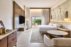a hotel room with a bed and a table at JW Marriott Tucson Starr Pass Resort in Tucson