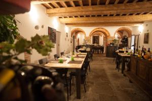 a restaurant with tables and chairs in a building at Relais Villa Scarfantoni B&B in Montemurlo