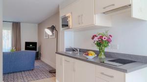 a kitchen with a vase of flowers on a counter at Castle Oaks House Hotel in Limerick