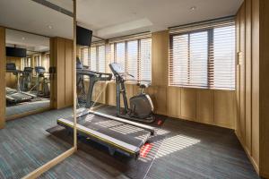 a room with a gym with a treadmill and a mirror at Yong Le Lukang, a Tribute Portfolio Hotel in Lukang