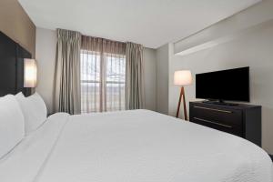 a hotel room with a bed and a flat screen tv at Residence Inn Paducah in Paducah +15 photos