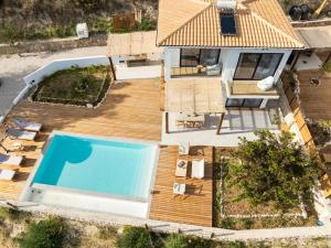 an aerial view of a house with a swimming pool at ELGIAN Luxury Villa -Private Pool & Sea View in Póndi