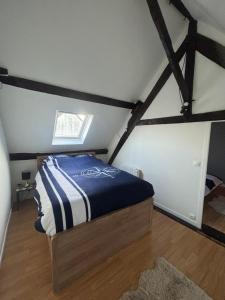 a bedroom with a bed in a attic at Maison in Verneuil-en-Halatte