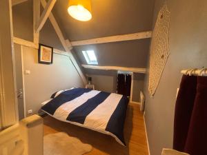 a bedroom with a bed in a room at Maison in Verneuil-en-Halatte