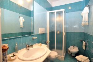 a bathroom with a sink and a toilet and a shower at Hotel La Casa sul Mare in Procida +72 photos