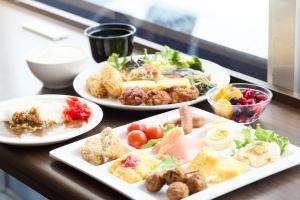 a table with three plates of food on it at Urbain Hiroshima Central in Hiroshima