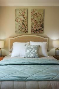 a bedroom with a bed with two paintings on the wall at Red Door Collective - RDC Vineyard Estate, Luxury Adult Only Stay in Pokolbin +72 photos