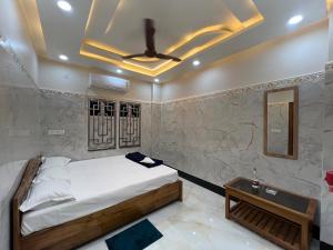 a bedroom with a bed and a ceiling fan at Jalangi Empire in mayapur