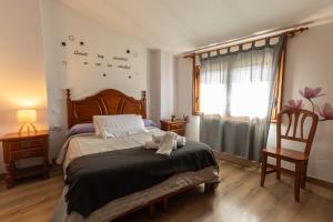 a bedroom with a bed with birds on the wall at Hostal La Balsá in La Alberca +13 photos