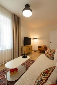 a living room with a couch and a table at ATRIUM City Center Apartment in Kaunas