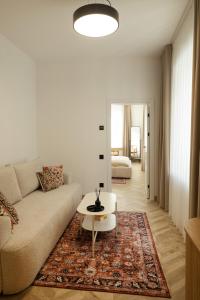 a living room with a couch and a coffee table at ATRIUM City Center Apartment in Kaunas
