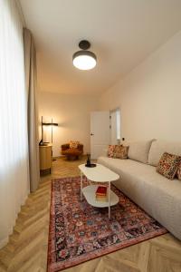 a living room with a couch and a table at ATRIUM City Center Apartment in Kaunas +10 photos