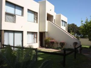 a white building with plants in front of it at Amies Self-Catering Apartments in Panorama +6 photos