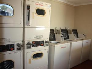 a row of washers and dryers in a room at Amies Self-Catering Apartments in Panorama