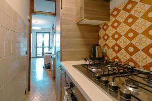 a kitchen with a stove and a counter top at House Carla in Bellano +13 photos