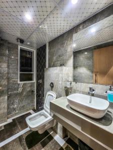 a bathroom with a sink and a toilet at The Falcon Inn - Clare Road in Mumbai +22 photos