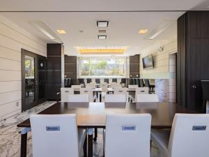 a conference room with a large table and white chairs at MyHotel Okazaki in Okazaki +47 photos