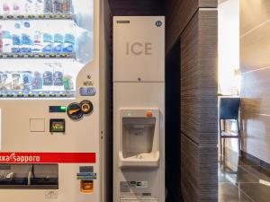 an ice machine is next to a refrigerator at MyHotel Okazaki in Okazaki