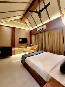 a bedroom with a large bed and a couch at The Falcon Inn - Clare Road in Mumbai