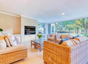 a living room with two couches and a table at Riverside Rhapsody, Vaal River, Vanderbijlpark, 6 Adults and 4 Children in Vanderbijlpark