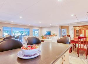 a living room with a bowl of fruit on a table at Riverside Rhapsody, Vaal River, Vanderbijlpark, 6 Adults and 4 Children in Vanderbijlpark +33 photos