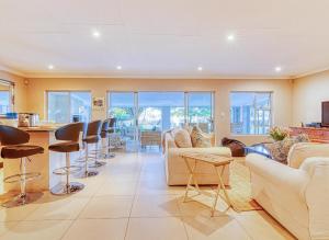 a living room with a couch and a table at Riverside Rhapsody, Vaal River, Vanderbijlpark, 6 Adults and 4 Children in Vanderbijlpark