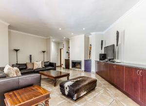 a living room with a couch and a tv at Elements Bush Villa 216 in Moheme