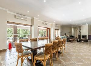 a large dining room with a table and chairs at Elements Bush Villa 216 in Moheme