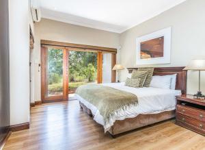 a bedroom with a large bed and a window at Elements Bush Villa 216 in Moheme +39 photos