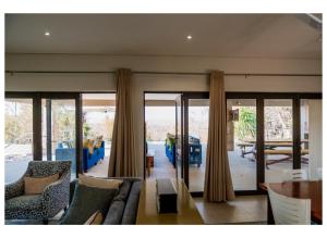 a living room with a couch and a table at Elements Private Golf Villa 295 in Warmbaths